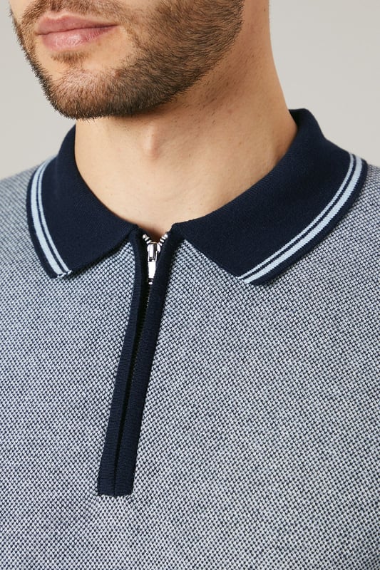 Birdseye knitted texture for a sophisticated look
        Contrasting collar and cuffs for a smart finish
        Quarter-zip neckline for adjustable comfort
        Short sleeves ideal for warmer weather
        Versatile design suitable for various casual occasions
    
    This Maine birdseye knitted polo shirt combines comfort with style, making it a versatile addition to your wardrobe. The textured knit adds depth and interest to the garment, while the contrasting collar and cuffs create a refined edge. Perfect for casual outings, this polo can be effortlessly styled for a range of events. Pair it with dark trousers and white trainers for a smart-casual look ideal for family gatherings or weekend brunches. The quarter-zip neckline allows for customisable comfort, adapting to your preference and the weather. Made from 100% cotton, this polo ensures breathability and ease of care, making it a practical choice for the modern man who values both style and functionality. Whether you're heading to a casual meet-up with friends or a relaxed day out, this Maine polo will keep you looking polished without compromising on comfort.