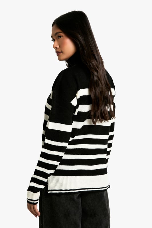 Bold striped pattern for a striking visual impact
        Cosy roll neck design for extra warmth
        Long sleeves with ribbed cuffs for a snug fit
        Relaxed silhouette for comfortable everyday wear
        Versatile design suitable for various casual occasions
    
    Make a statement with this eye-catching Stripe Roll Neck Jumper from Boohoo. The bold contrast between the stripes creates a captivating look that's sure to turn heads. Perfect for the fashion-forward woman who loves to stay on-trend, this jumper offers both style and comfort. The roll neck provides extra warmth on chilly days, while the relaxed fit ensures ease of movement. Style it with wide-leg trousers and chunky boots for a contemporary casual look, or pair it with a midi skirt and trainers for a chic weekend ensemble. Ideal for family gatherings, coffee dates with friends, or casual outings, this jumper is a versatile addition to your wardrobe that can be dressed up or down with ease. Its timeless design ensures it will remain a favourite for seasons to come.
