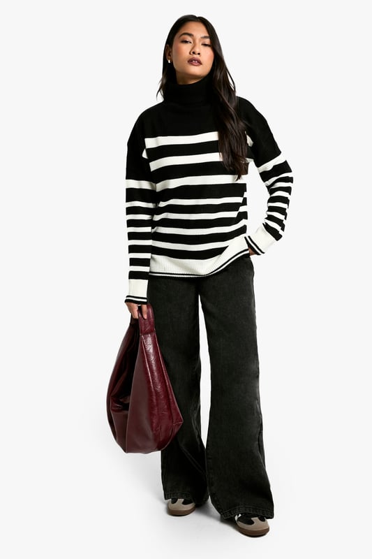 Bold striped pattern for a striking visual impact
        Cosy roll neck design for extra warmth
        Long sleeves with ribbed cuffs for a snug fit
        Relaxed silhouette for comfortable everyday wear
        Versatile design suitable for various casual occasions
    
    Make a statement with this eye-catching Stripe Roll Neck Jumper from Boohoo. The bold contrast between the stripes creates a captivating look that's sure to turn heads. Perfect for the fashion-forward woman who loves to stay on-trend, this jumper offers both style and comfort. The roll neck provides extra warmth on chilly days, while the relaxed fit ensures ease of movement. Style it with wide-leg trousers and chunky boots for a contemporary casual look, or pair it with a midi skirt and trainers for a chic weekend ensemble. Ideal for family gatherings, coffee dates with friends, or casual outings, this jumper is a versatile addition to your wardrobe that can be dressed up or down with ease. Its timeless design ensures it will remain a favourite for seasons to come.