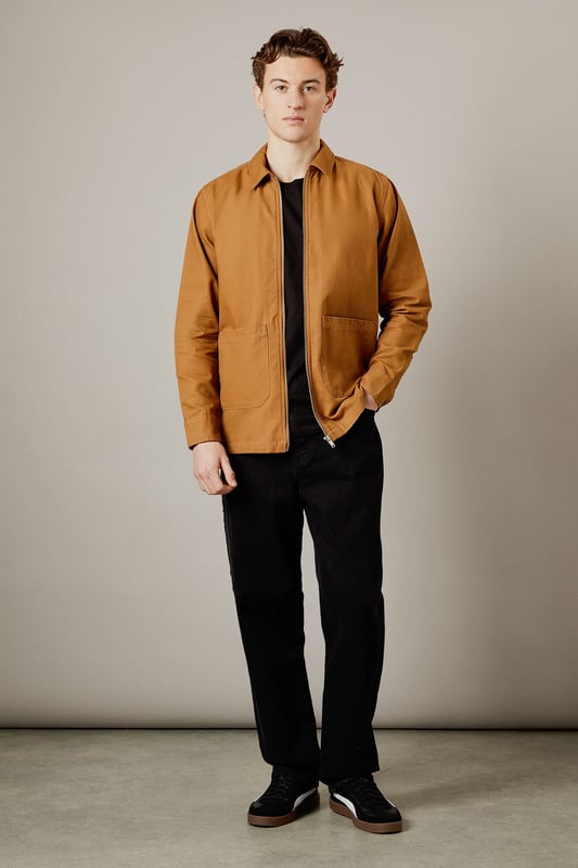 Tan Logan Canvas Jacket Versatile canvas jacket with a classic collar design
Full-length zip closure for easy wear
Spacious patch pockets for practicality
Clean-cut silhouette with a straight hem
Durable woven fabric ideal for everyday wear
The Logan Canvas Jacket from Burton is a quintessential piece for the modern British gent who values both style and functionality. This jacket strikes the perfect balance between casual cool and practical design, making it an ideal choice for various occasions. Pair it with dark trousers and trainers for a laid-back pub outing with mates, or throw it over a crisp shirt for family gatherings. The versatile nature of this jacket allows for effortless styling, whether you're heading to a weekend football match or enjoying a casual day out. Its durable fabric ensures it can withstand the unpredictable British weather, while its timeless design means it'll remain a wardrobe staple for seasons to come. For a smart-casual look, layer it over a plain t-shirt and pair with chinos - perfect for those impromptu after-work drinks or a relaxed date night at your local.