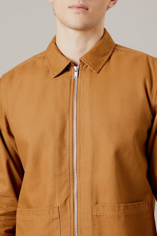 Tan Logan Canvas Jacket Versatile canvas jacket with a classic collar design
Full-length zip closure for easy wear
Spacious patch pockets for practicality
Clean-cut silhouette with a straight hem
Durable woven fabric ideal for everyday wear
The Logan Canvas Jacket from Burton is a quintessential piece for the modern British gent who values both style and functionality. This jacket strikes the perfect balance between casual cool and practical design, making it an ideal choice for various occasions. Pair it with dark trousers and trainers for a laid-back pub outing with mates, or throw it over a crisp shirt for family gatherings. The versatile nature of this jacket allows for effortless styling, whether you're heading to a weekend football match or enjoying a casual day out. Its durable fabric ensures it can withstand the unpredictable British weather, while its timeless design means it'll remain a wardrobe staple for seasons to come. For a smart-casual look, layer it over a plain t-shirt and pair with chinos - perfect for those impromptu after-work drinks or a relaxed date night at your local.