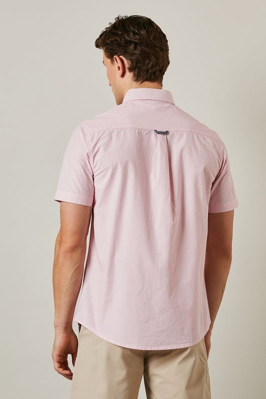 Fine stripe pattern adds subtle visual interest to this classic short sleeve shirt
        Button-down collar provides a neat, structured finish
        Convenient chest pocket detail for added functionality
        Crafted from pure cotton for breathable comfort in warmer weather
        Regular fit design offers ease of movement for everyday wear
    
    This Maine short sleeve shirt combines timeless style with warm-weather practicality. The fine stripe pattern creates a refined yet relaxed aesthetic that transitions effortlessly from day to evening occasions. Style it as seen with neutral chino shorts and white trainers for a polished casual look perfect for weekend brunches or garden gatherings. For smarter occasions, pair with tailored trousers and loafers. The pure cotton fabric ensures all-day comfort even during the warmest days, while the versatile design makes it an essential addition to your summer wardrobe. The button-down collar maintains a neat appearance throughout wear, making this shirt equally suitable for casual office environments or laid-back social events. A true wardrobe staple that offers endless styling possibilities throughout the season.