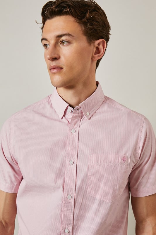 Fine stripe pattern adds subtle visual interest to this classic short sleeve shirt
        Button-down collar provides a neat, structured finish
        Convenient chest pocket detail for added functionality
        Crafted from pure cotton for breathable comfort in warmer weather
        Regular fit design offers ease of movement for everyday wear
    
    This Maine short sleeve shirt combines timeless style with warm-weather practicality. The fine stripe pattern creates a refined yet relaxed aesthetic that transitions effortlessly from day to evening occasions. Style it as seen with neutral chino shorts and white trainers for a polished casual look perfect for weekend brunches or garden gatherings. For smarter occasions, pair with tailored trousers and loafers. The pure cotton fabric ensures all-day comfort even during the warmest days, while the versatile design makes it an essential addition to your summer wardrobe. The button-down collar maintains a neat appearance throughout wear, making this shirt equally suitable for casual office environments or laid-back social events. A true wardrobe staple that offers endless styling possibilities throughout the season.