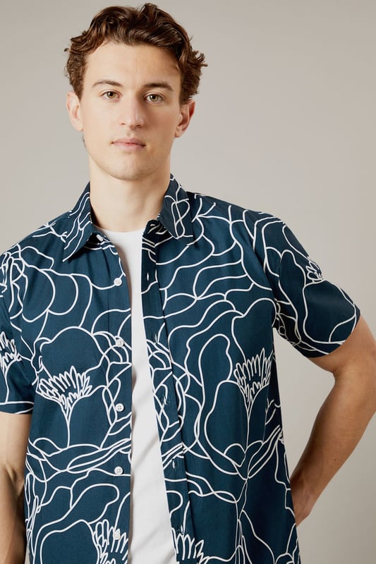Bold sketch floral pattern creates a distinctive contemporary look
        Short sleeve design perfect for warmer days
        Classic collar with button-through front
        Relaxed fit for comfortable all-day wear
        100% cotton fabric ensures breathability and comfort
    
    Make a statement with this eye-catching Burton sketch floral shirt. The striking linear pattern offers a modern twist on traditional florals, making it an ideal choice for the man who appreciates classic style with a contemporary edge. Pair with neutral chinos as shown for a balanced look that works brilliantly for casual gatherings or weekend pub visits. The breathable cotton construction ensures comfort throughout the day, whilst the versatile design can be worn buttoned up or open over a plain t-shirt for different styling options. Perfect for summer barbecues, casual Fridays at the office, or meeting mates for a pint. This shirt transitions effortlessly from daytime casual to evening socialising - simply add dark jeans and trainers to complete the look. Machine washable at 30 degrees for easy care.