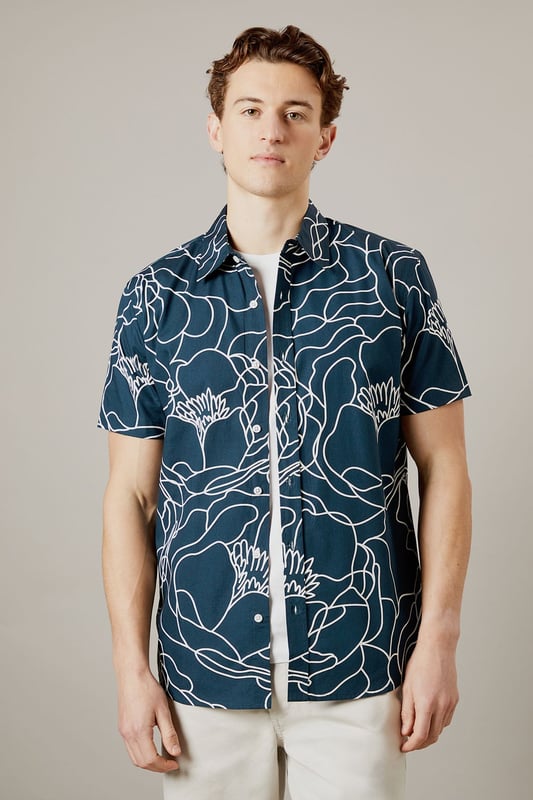 Bold sketch floral pattern creates a distinctive contemporary look
        Short sleeve design perfect for warmer days
        Classic collar with button-through front
        Relaxed fit for comfortable all-day wear
        100% cotton fabric ensures breathability and comfort
    
    Make a statement with this eye-catching Burton sketch floral shirt. The striking linear pattern offers a modern twist on traditional florals, making it an ideal choice for the man who appreciates classic style with a contemporary edge. Pair with neutral chinos as shown for a balanced look that works brilliantly for casual gatherings or weekend pub visits. The breathable cotton construction ensures comfort throughout the day, whilst the versatile design can be worn buttoned up or open over a plain t-shirt for different styling options. Perfect for summer barbecues, casual Fridays at the office, or meeting mates for a pint. This shirt transitions effortlessly from daytime casual to evening socialising - simply add dark jeans and trainers to complete the look. Machine washable at 30 degrees for easy care.