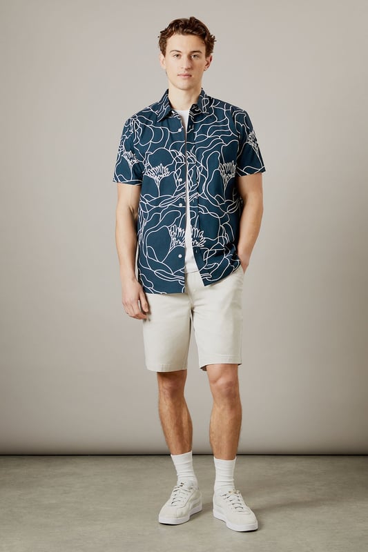 Bold sketch floral pattern creates a distinctive contemporary look
        Short sleeve design perfect for warmer days
        Classic collar with button-through front
        Relaxed fit for comfortable all-day wear
        100% cotton fabric ensures breathability and comfort
    
    Make a statement with this eye-catching Burton sketch floral shirt. The striking linear pattern offers a modern twist on traditional florals, making it an ideal choice for the man who appreciates classic style with a contemporary edge. Pair with neutral chinos as shown for a balanced look that works brilliantly for casual gatherings or weekend pub visits. The breathable cotton construction ensures comfort throughout the day, whilst the versatile design can be worn buttoned up or open over a plain t-shirt for different styling options. Perfect for summer barbecues, casual Fridays at the office, or meeting mates for a pint. This shirt transitions effortlessly from daytime casual to evening socialising - simply add dark jeans and trainers to complete the look. Machine washable at 30 degrees for easy care.