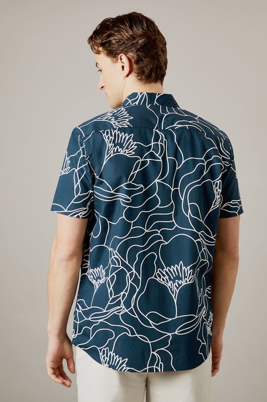 Bold sketch floral pattern creates a distinctive contemporary look
        Short sleeve design perfect for warmer days
        Classic collar with button-through front
        Relaxed fit for comfortable all-day wear
        100% cotton fabric ensures breathability and comfort
    
    Make a statement with this eye-catching Burton sketch floral shirt. The striking linear pattern offers a modern twist on traditional florals, making it an ideal choice for the man who appreciates classic style with a contemporary edge. Pair with neutral chinos as shown for a balanced look that works brilliantly for casual gatherings or weekend pub visits. The breathable cotton construction ensures comfort throughout the day, whilst the versatile design can be worn buttoned up or open over a plain t-shirt for different styling options. Perfect for summer barbecues, casual Fridays at the office, or meeting mates for a pint. This shirt transitions effortlessly from daytime casual to evening socialising - simply add dark jeans and trainers to complete the look. Machine washable at 30 degrees for easy care.