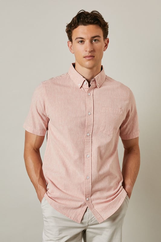 Textured woven fabric with subtle surface interest for added dimension
        Classic button-down collar for a smart-casual finish
        Convenient chest pocket detail for practical styling
        Short sleeves with neat hems perfect for warmer days
        Centre back pleat providing enhanced comfort and movement
    
    This Maine textured short sleeve shirt combines relaxed comfort with understated style. The button-down collar offers a refined touch whilst maintaining a laid-back feel, making it ideal for casual settings. Style as shown with light-coloured chino shorts and white trainers for effortless summer outings, or pair with tailored trousers for garden parties and family gatherings. The textured fabric adds subtle character to your ensemble without overwhelming it. For cooler evenings, layer under a lightweight bomber jacket or cardigan. This versatile shirt transitions seamlessly from daytime casual to evening drinks, making it an essential addition to your warm-weather wardrobe. The relaxed fit ensures all-day comfort whilst maintaining a put-together appearance that works across multiple settings.