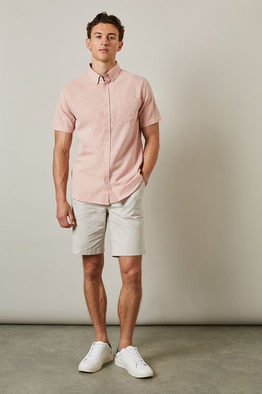 Textured woven fabric with subtle surface interest for added dimension
        Classic button-down collar for a smart-casual finish
        Convenient chest pocket detail for practical styling
        Short sleeves with neat hems perfect for warmer days
        Centre back pleat providing enhanced comfort and movement
    
    This Maine textured short sleeve shirt combines relaxed comfort with understated style. The button-down collar offers a refined touch whilst maintaining a laid-back feel, making it ideal for casual settings. Style as shown with light-coloured chino shorts and white trainers for effortless summer outings, or pair with tailored trousers for garden parties and family gatherings. The textured fabric adds subtle character to your ensemble without overwhelming it. For cooler evenings, layer under a lightweight bomber jacket or cardigan. This versatile shirt transitions seamlessly from daytime casual to evening drinks, making it an essential addition to your warm-weather wardrobe. The relaxed fit ensures all-day comfort whilst maintaining a put-together appearance that works across multiple settings.