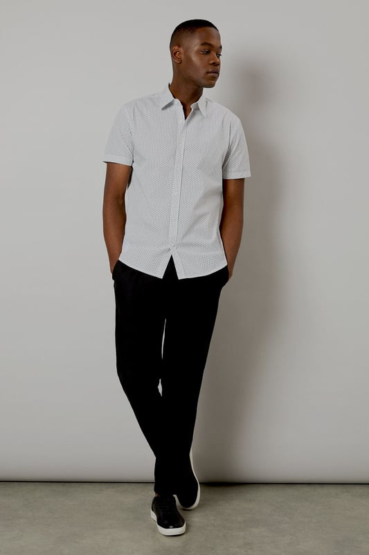 Crafted from pure cotton for exceptional comfort and breathability
        Subtle geo print pattern adds contemporary visual interest
        Classic collar and button-through front for a timeless silhouette
        Short sleeves designed for warm-weather versatility
        Regular fit provides ease of movement for all-day wear
    
    This Burton geo print shirt combines classic styling with modern detailing, perfect for the man who appreciates understated sophistication. The lightweight cotton construction makes it ideal for casual summer occasions, whilst the versatile design allows for effortless styling. Pair with dark trousers as shown for an evening at the pub with mates, or team with chino shorts for family barbecues and weekend outings. The clean lines and subtle pattern work equally well for casual Fridays at the office - simply add a lightweight blazer to sharpen the look. Easy to care for and comfortable to wear, this shirt represents the perfect balance of practicality and style that Burton is known for. A wardrobe essential that will serve you well throughout the warmer months.