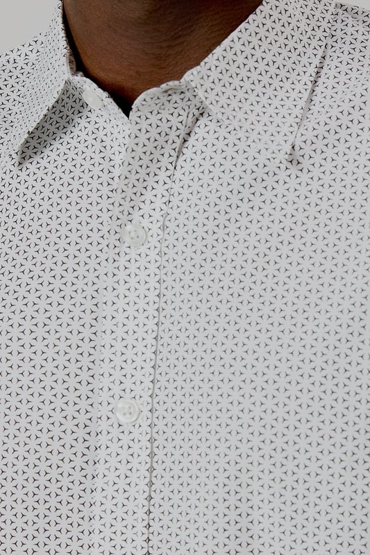 Crafted from pure cotton for exceptional comfort and breathability
        Subtle geo print pattern adds contemporary visual interest
        Classic collar and button-through front for a timeless silhouette
        Short sleeves designed for warm-weather versatility
        Regular fit provides ease of movement for all-day wear
    
    This Burton geo print shirt combines classic styling with modern detailing, perfect for the man who appreciates understated sophistication. The lightweight cotton construction makes it ideal for casual summer occasions, whilst the versatile design allows for effortless styling. Pair with dark trousers as shown for an evening at the pub with mates, or team with chino shorts for family barbecues and weekend outings. The clean lines and subtle pattern work equally well for casual Fridays at the office - simply add a lightweight blazer to sharpen the look. Easy to care for and comfortable to wear, this shirt represents the perfect balance of practicality and style that Burton is known for. A wardrobe essential that will serve you well throughout the warmer months.