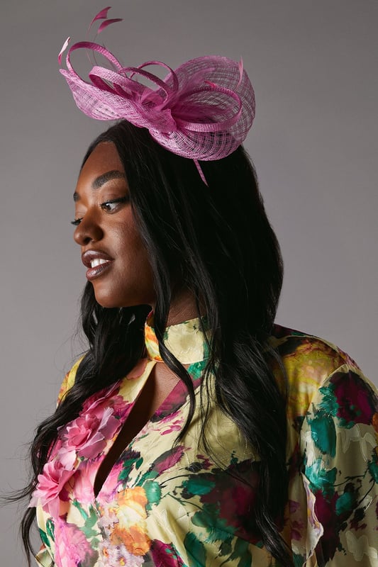 Offering a bold take on race-day style or adding a flair to wedding guest dressing, fascinators are our favourite accessory. Beautifully complementing our formal outfitting, this hat is an instant sartorial statement. Crafted out of signature sinamay, a natural straw fabric made from abaca fibres, this  piece uses an open weave to add texture and is sculpted into loops. Fixes with a headband and delivered in a box.