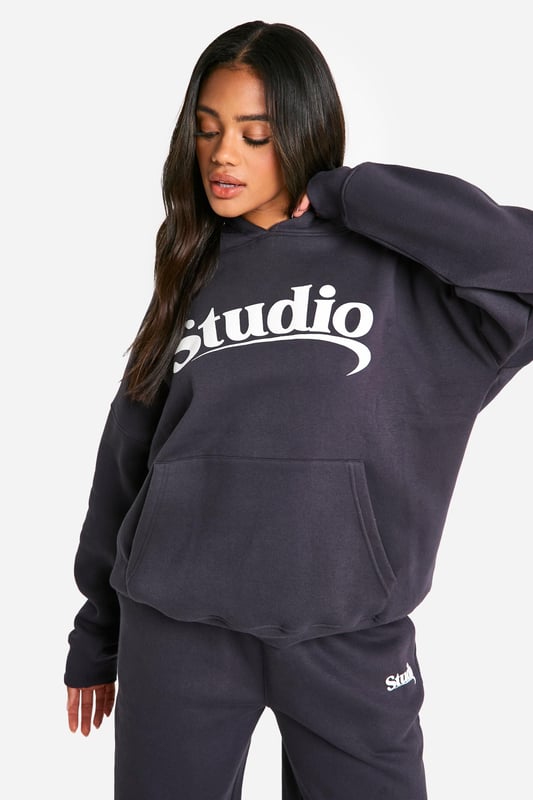 Oversized fit for ultimate comfort and style
        Bold 'Studio' slogan print across the chest
        Spacious hood for added warmth and casual flair
        Convenient front pocket for essentials
        Ribbed cuffs and hem for a snug fit
    
    Make a statement in this trendy oversized hoodie, perfect for those who love to combine comfort with street-style edge. The bold 'Studio' slogan across the chest adds a touch of urban cool to your casual wardrobe. Pair it with wide-leg trousers and trainers for a relaxed weekend look, or throw it over cycling shorts and chunky boots for an edgy athleisure vibe. Ideal for lazy Sundays, coffee runs, or casual meet-ups with friends, this hoodie is versatile enough to take you from daytime errands to evening chill-outs. Layer it over a long-sleeved tee for extra warmth during cooler months, or wear it solo as a comfy throw-on piece. The oversized fit allows for easy movement, making it a go-to choice for your active lifestyle. Whether you're heading to the gym, running errands, or simply lounging at home, this hoodie promises to keep you stylish and cosy all day long.