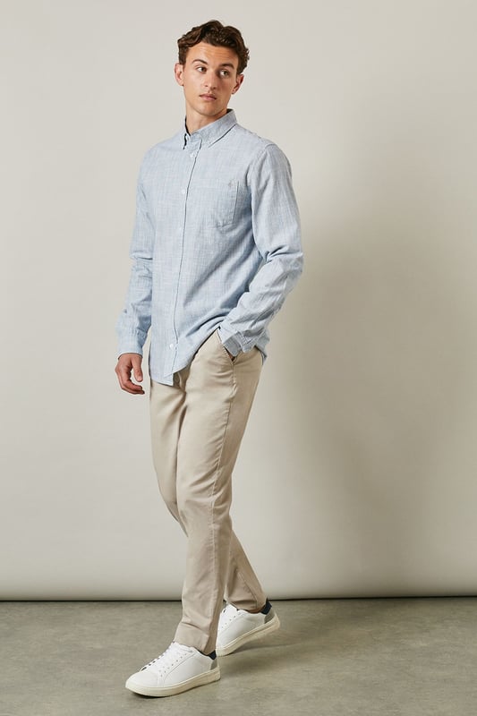 Textured woven cotton fabric for breathable comfort
        Classic button-down collar for a refined casual look
        Convenient chest pocket for practical detailing
        Long sleeves with buttoned cuffs for versatile styling
        Regular fit silhouette suitable for various body types
    
    This Maine textured long sleeve shirt combines timeless design with everyday wearability. The subtle texture adds visual interest whilst maintaining a clean, sophisticated appearance. Style it as seen with neutral chinos and white trainers for a relaxed weekend look, or dress it up with tailored trousers and loafers for smart-casual occasions. The button-down collar keeps everything looking neat, whether worn open over a t-shirt or buttoned up for family gatherings. Made from 100% cotton, this shirt offers natural comfort throughout the day. Perfect for transitional weather, layer under a lightweight jumper or wear solo when temperatures rise. A wardrobe essential that bridges the gap between casual and smart with effortless British style.