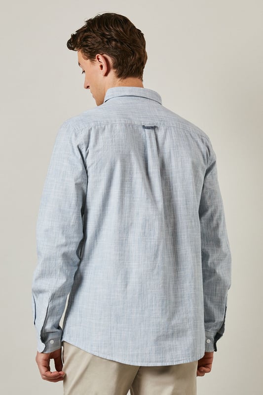 Textured woven cotton fabric for breathable comfort
        Classic button-down collar for a refined casual look
        Convenient chest pocket for practical detailing
        Long sleeves with buttoned cuffs for versatile styling
        Regular fit silhouette suitable for various body types
    
    This Maine textured long sleeve shirt combines timeless design with everyday wearability. The subtle texture adds visual interest whilst maintaining a clean, sophisticated appearance. Style it as seen with neutral chinos and white trainers for a relaxed weekend look, or dress it up with tailored trousers and loafers for smart-casual occasions. The button-down collar keeps everything looking neat, whether worn open over a t-shirt or buttoned up for family gatherings. Made from 100% cotton, this shirt offers natural comfort throughout the day. Perfect for transitional weather, layer under a lightweight jumper or wear solo when temperatures rise. A wardrobe essential that bridges the gap between casual and smart with effortless British style.