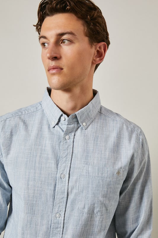 Textured woven cotton fabric for breathable comfort
        Classic button-down collar for a refined casual look
        Convenient chest pocket for practical detailing
        Long sleeves with buttoned cuffs for versatile styling
        Regular fit silhouette suitable for various body types
    
    This Maine textured long sleeve shirt combines timeless design with everyday wearability. The subtle texture adds visual interest whilst maintaining a clean, sophisticated appearance. Style it as seen with neutral chinos and white trainers for a relaxed weekend look, or dress it up with tailored trousers and loafers for smart-casual occasions. The button-down collar keeps everything looking neat, whether worn open over a t-shirt or buttoned up for family gatherings. Made from 100% cotton, this shirt offers natural comfort throughout the day. Perfect for transitional weather, layer under a lightweight jumper or wear solo when temperatures rise. A wardrobe essential that bridges the gap between casual and smart with effortless British style.