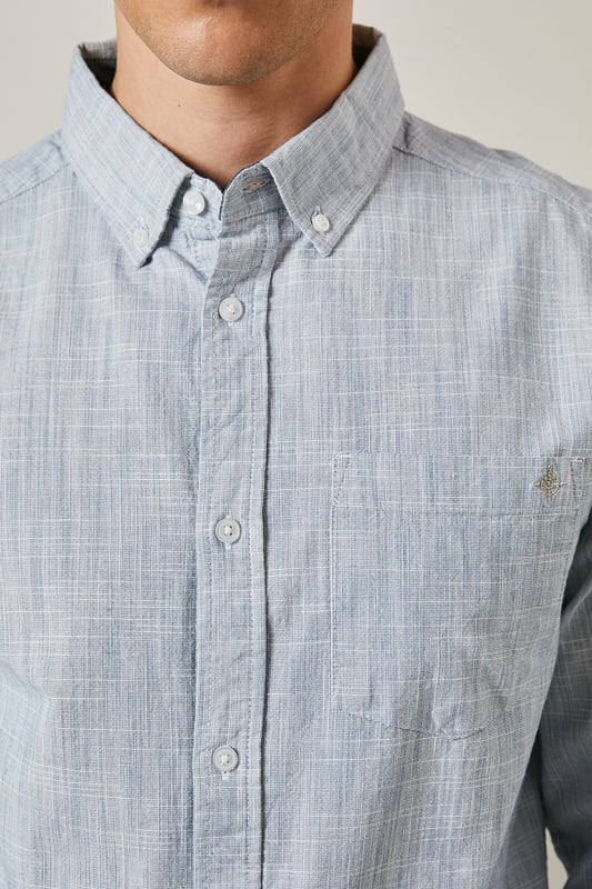 Textured woven cotton fabric for breathable comfort
        Classic button-down collar for a refined casual look
        Convenient chest pocket for practical detailing
        Long sleeves with buttoned cuffs for versatile styling
        Regular fit silhouette suitable for various body types
    
    This Maine textured long sleeve shirt combines timeless design with everyday wearability. The subtle texture adds visual interest whilst maintaining a clean, sophisticated appearance. Style it as seen with neutral chinos and white trainers for a relaxed weekend look, or dress it up with tailored trousers and loafers for smart-casual occasions. The button-down collar keeps everything looking neat, whether worn open over a t-shirt or buttoned up for family gatherings. Made from 100% cotton, this shirt offers natural comfort throughout the day. Perfect for transitional weather, layer under a lightweight jumper or wear solo when temperatures rise. A wardrobe essential that bridges the gap between casual and smart with effortless British style.