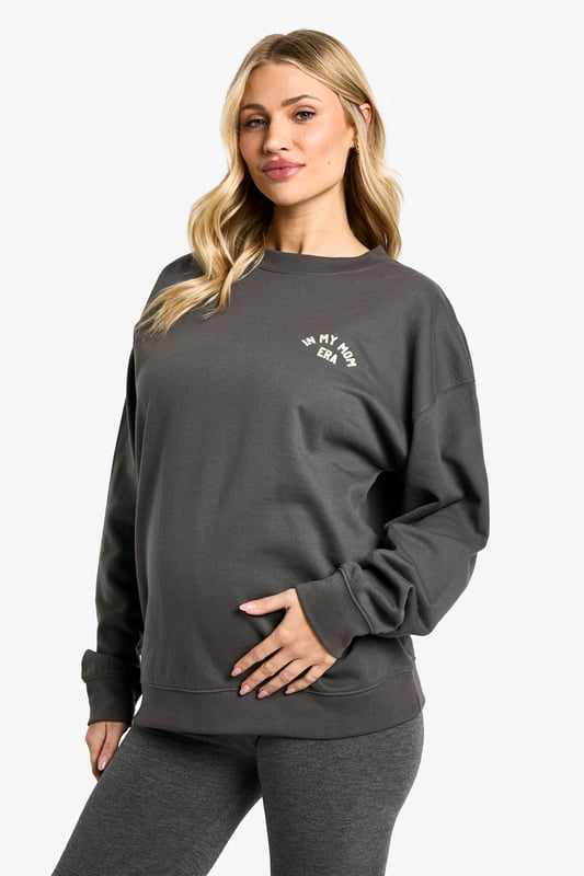 Comfortable maternity hoodie and leggings set
        Relaxed fit hoodie with 'In My Mom Era' slogan
        Stretchy leggings for growing bump
        Versatile for lounging or light exercise
        Soft cotton blend fabric for all-day comfort
    
    Embrace your journey into motherhood with this chic and cosy maternity tracksuit set. The relaxed-fit hoodie features a playful 'In My Mom Era' slogan, perfect for showcasing your new status with pride. Paired with stretchy leggings that accommodate your growing bump, this set offers supreme comfort for your changing body. Whether you're heading to a prenatal yoga class or simply relaxing at home, this versatile ensemble has got you covered. Style it with trendy trainers and a roomy tote for a quick coffee run, or layer with a denim jacket for a casual day out. The soft cotton blend fabric ensures all-day comfort, making this set an essential addition to your maternity wardrobe. It's the ideal choice for the fashion-forward mum-to-be who wants to stay on-trend while prioritising comfort during this special time.