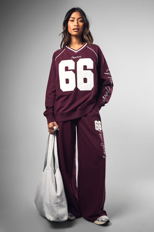 Wide-leg design for ultimate comfort and style
        Bold '66' graphic print on leg
        Coordinating sweatshirt available for a matching set
        Relaxed fit perfect for lounging or casual outings
        Versatile piece that can be dressed up or down
    
    Make a statement in these eye-catching Dsgn Sport 66 wide-leg joggers from Boohoo. Perfect for the fashion-forward woman who values both style and comfort, these joggers offer a relaxed fit with a trendy wide-leg silhouette. The standout '66' graphic print adds a sporty edge, whilst the soft cotton blend fabric ensures all-day comfort. Style these versatile joggers with the matching sweatshirt for a coordinated look, or mix and match with a cropped tee and trainers for a more casual vibe. Ideal for lazy weekends, running errands, or meeting friends for coffee, these joggers effortlessly blend athleisure with street style. For a more polished look, pair with a fitted bodysuit and chunky jewellery. Whatever the occasion, these Dsgn Sport 66 joggers are sure to become a go-to piece in your wardrobe.