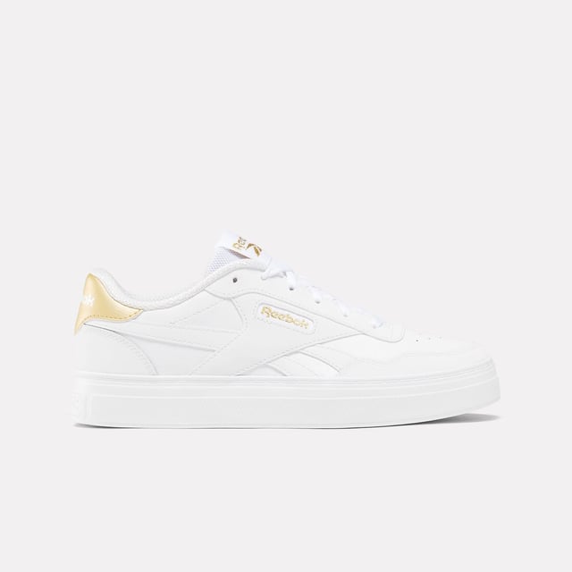 Womens Reebok Classics Court Advance Clip Trainers in white - gold.All the Reebok court design you love. These shoes mash up the icons Club C 85 and Club C Revenge to make the new Court Advance. The tennis-inspired low-top silhouette features a sleek panelled upper with a contrast heel clip and classic windowbox. Foam cushioning and DMX bubbles at the sole provide all-day comfort.- Synthetic upper.- Lace-up front fastening.- Padded ankle collar and tongue.- Perforated toe box.- Reinforced toe cap.- Logo at heel and windowbox.- Logo tab at tongue.- EVA foam midsole with debossed stripes.- DMX Microbubbles in midsole.- Rubber outsole.- Ref: 100207971