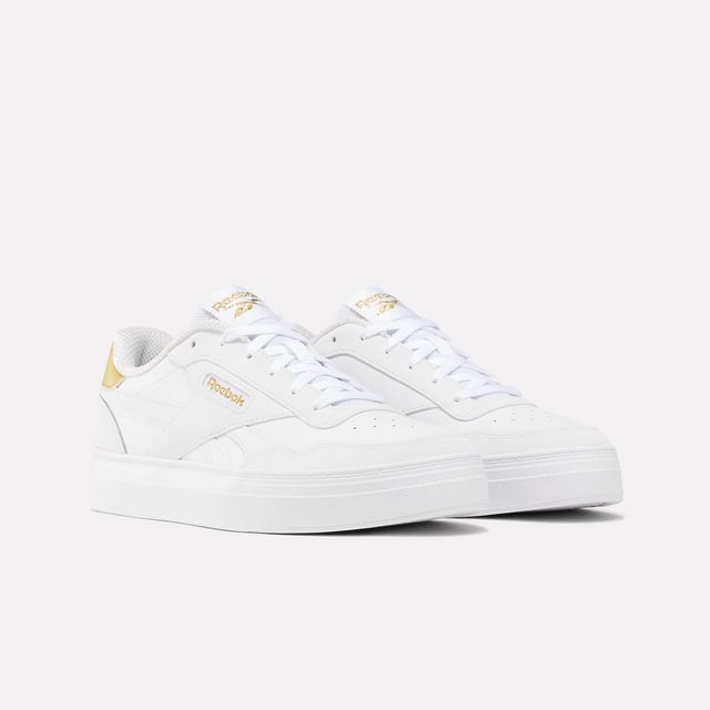 Womens Reebok Classics Court Advance Clip Trainers in white - gold.All the Reebok court design you love. These shoes mash up the icons Club C 85 and Club C Revenge to make the new Court Advance. The tennis-inspired low-top silhouette features a sleek panelled upper with a contrast heel clip and classic windowbox. Foam cushioning and DMX bubbles at the sole provide all-day comfort.- Synthetic upper.- Lace-up front fastening.- Padded ankle collar and tongue.- Perforated toe box.- Reinforced toe cap.- Logo at heel and windowbox.- Logo tab at tongue.- EVA foam midsole with debossed stripes.- DMX Microbubbles in midsole.- Rubber outsole.- Ref: 100207971