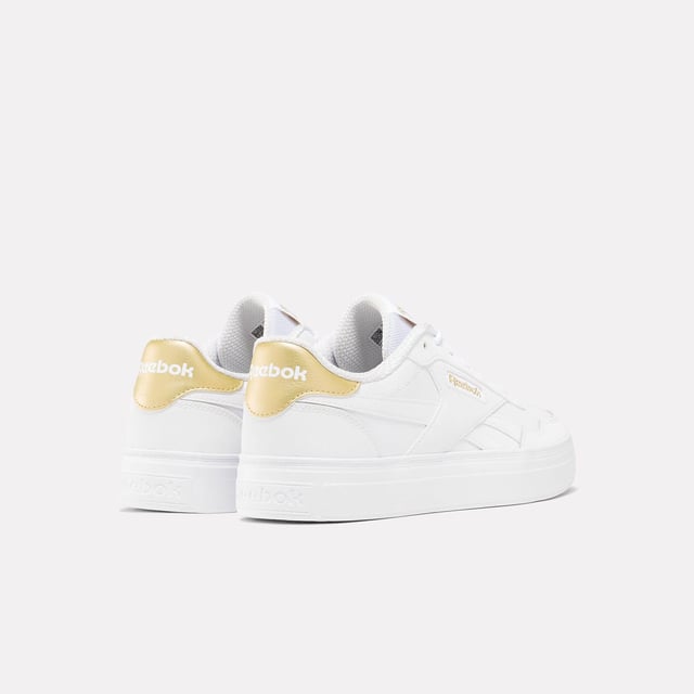 Womens Reebok Classics Court Advance Clip Trainers in white - gold.All the Reebok court design you love. These shoes mash up the icons Club C 85 and Club C Revenge to make the new Court Advance. The tennis-inspired low-top silhouette features a sleek panelled upper with a contrast heel clip and classic windowbox. Foam cushioning and DMX bubbles at the sole provide all-day comfort.- Synthetic upper.- Lace-up front fastening.- Padded ankle collar and tongue.- Perforated toe box.- Reinforced toe cap.- Logo at heel and windowbox.- Logo tab at tongue.- EVA foam midsole with debossed stripes.- DMX Microbubbles in midsole.- Rubber outsole.- Ref: 100207971