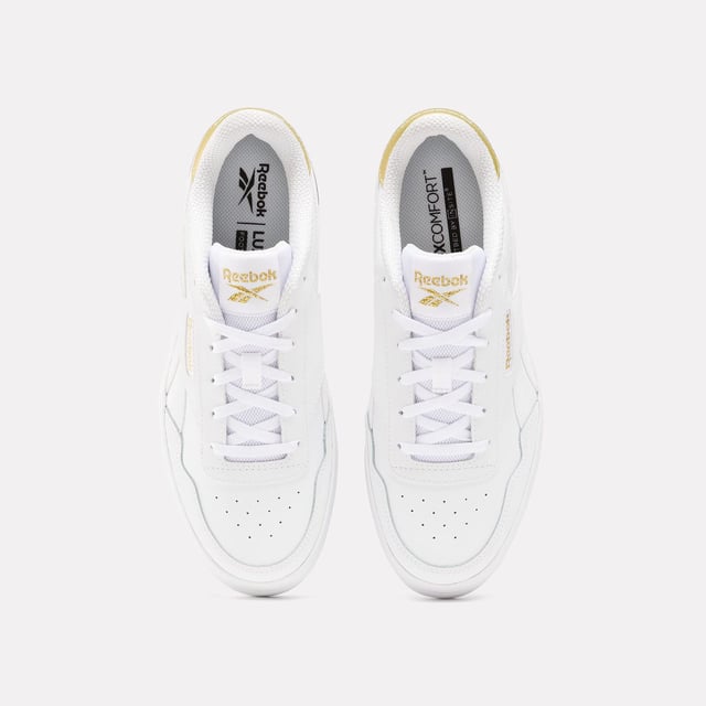 Womens Reebok Classics Court Advance Clip Trainers in white - gold.All the Reebok court design you love. These shoes mash up the icons Club C 85 and Club C Revenge to make the new Court Advance. The tennis-inspired low-top silhouette features a sleek panelled upper with a contrast heel clip and classic windowbox. Foam cushioning and DMX bubbles at the sole provide all-day comfort.- Synthetic upper.- Lace-up front fastening.- Padded ankle collar and tongue.- Perforated toe box.- Reinforced toe cap.- Logo at heel and windowbox.- Logo tab at tongue.- EVA foam midsole with debossed stripes.- DMX Microbubbles in midsole.- Rubber outsole.- Ref: 100207971