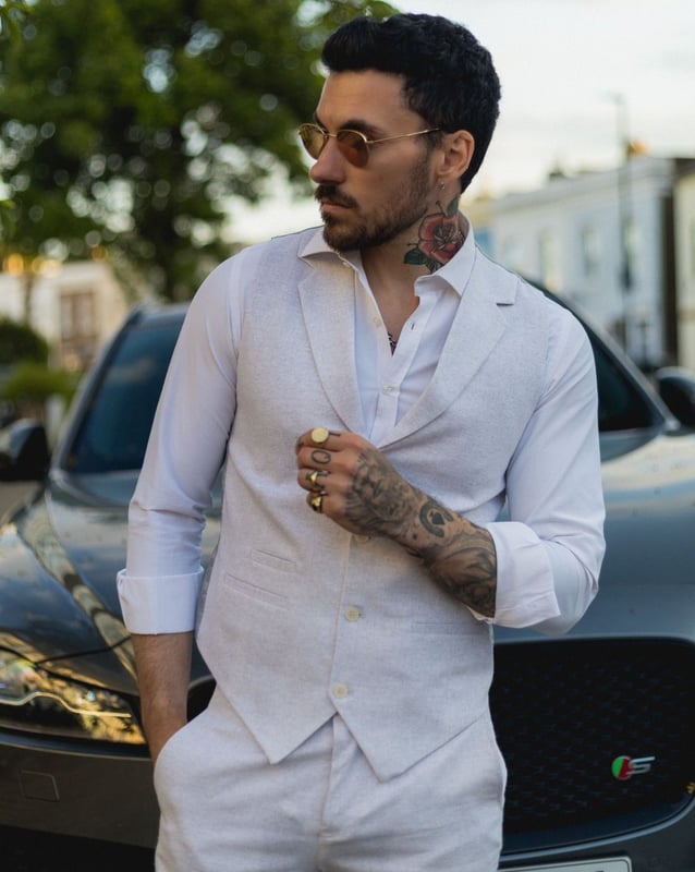 Embrace effortless summer sophistication with this grey 2-piece linen suit, designed with comfort and style in mind. Featuring a coordinating waistcoat and trousers, this ensemble is ideal for warm-weather occasions. The lightweight and breathable linen blend keeps you cool and comfortable, even on the hottest days. With its relaxed yet refined appearance, this suit strikes the perfect balance between smart and casual—ideal for garden parties, destination weddings, or daytime events. Whether dressed up with a crisp shirt or styled casually with loafers, this suit adapts easily to your look and lifestyle.\n2-piece set includes waistcoat and trousers in a light grey tone\nLightweight and breathable fabric perfect for summer events\nRelaxed yet stylish look, ideal for casual weddings or garden parties\nVersatile styling—elevate with formalwear or dress down for smart-casual looks\nMaterial: 80% Cotton, 20% Acrylic