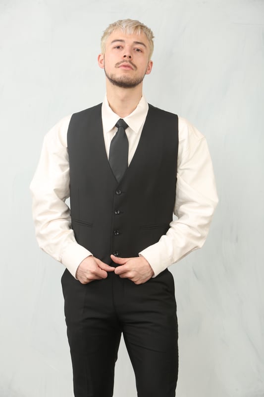 Step into timeless elegance with this tailored black 3-piece suit, designed to deliver both sophistication and comfort for any formal occasion. The classic plain black design ensures versatility across events—from weddings and proms to business meetings and evening functions. Expert tailoring offers a flattering, structured fit, while subtle stitch lapel detailing adds a refined touch. Complete with a blazer, waistcoat, and trousers, this suit is your go-to choice for a polished and confident look.\nTailored Fit: Structured for a modern silhouette that blends style and comfort.\nClassic Plain Black Design: Sleek and versatile, perfect for formal and professional events.\nComplete 3-Piece Set: Includes blazer, waistcoat, and trousers for a coordinated look.\nStitch Lapel Detailing: Adds subtle refinement and character to the overall design.\nMaterial Composition: 65% Polyester, 32% Viscose, 3% Lycra.