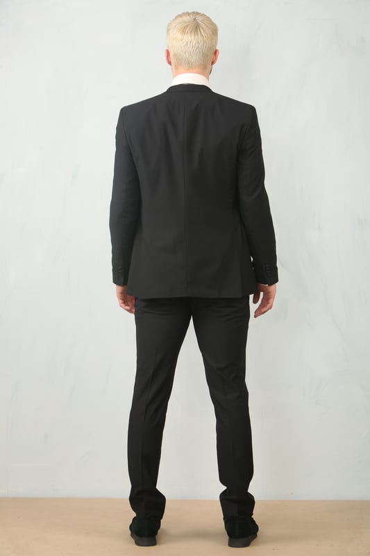 Step into timeless elegance with this tailored black 3-piece suit, designed to deliver both sophistication and comfort for any formal occasion. The classic plain black design ensures versatility across events—from weddings and proms to business meetings and evening functions. Expert tailoring offers a flattering, structured fit, while subtle stitch lapel detailing adds a refined touch. Complete with a blazer, waistcoat, and trousers, this suit is your go-to choice for a polished and confident look.\nTailored Fit: Structured for a modern silhouette that blends style and comfort.\nClassic Plain Black Design: Sleek and versatile, perfect for formal and professional events.\nComplete 3-Piece Set: Includes blazer, waistcoat, and trousers for a coordinated look.\nStitch Lapel Detailing: Adds subtle refinement and character to the overall design.\nMaterial Composition: 65% Polyester, 32% Viscose, 3% Lycra.