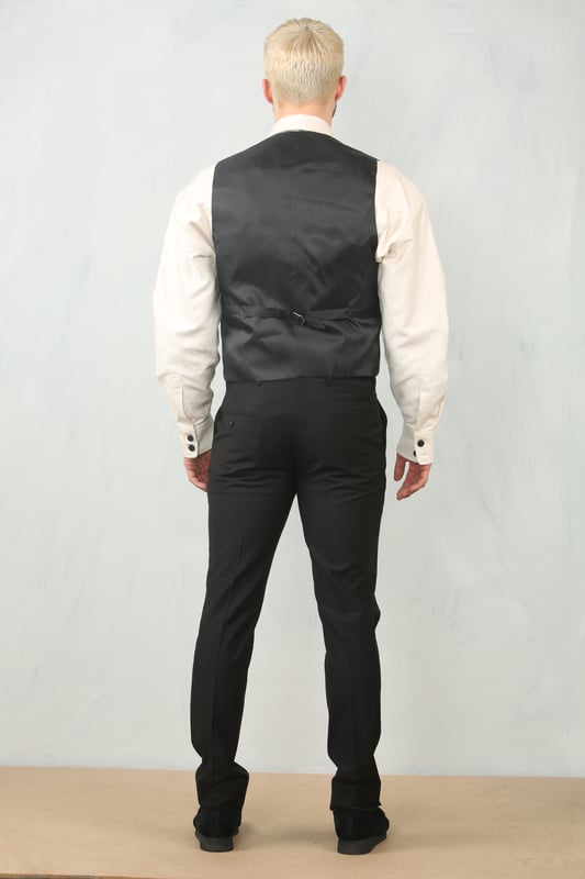 Step into timeless elegance with this tailored black 3-piece suit, designed to deliver both sophistication and comfort for any formal occasion. The classic plain black design ensures versatility across events—from weddings and proms to business meetings and evening functions. Expert tailoring offers a flattering, structured fit, while subtle stitch lapel detailing adds a refined touch. Complete with a blazer, waistcoat, and trousers, this suit is your go-to choice for a polished and confident look.\nTailored Fit: Structured for a modern silhouette that blends style and comfort.\nClassic Plain Black Design: Sleek and versatile, perfect for formal and professional events.\nComplete 3-Piece Set: Includes blazer, waistcoat, and trousers for a coordinated look.\nStitch Lapel Detailing: Adds subtle refinement and character to the overall design.\nMaterial Composition: 65% Polyester, 32% Viscose, 3% Lycra.