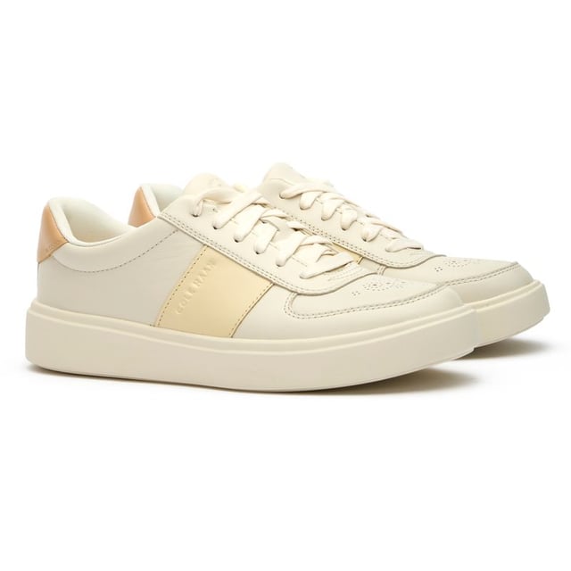Womens white Cole Haan grand court della trainers and a rubber sole. Featuring: high traction rubber outsole, fabric covered, foam midsole and branding to heel and quarter.
