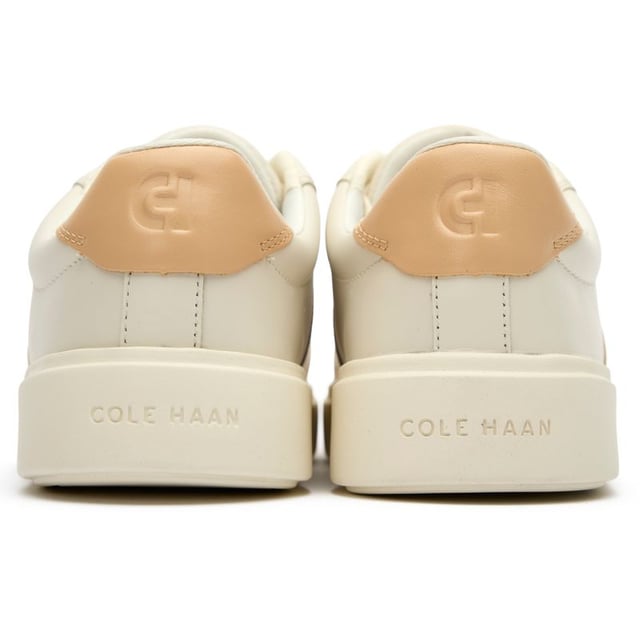 Womens white Cole Haan grand court della trainers and a rubber sole. Featuring: high traction rubber outsole, fabric covered, foam midsole and branding to heel and quarter.
