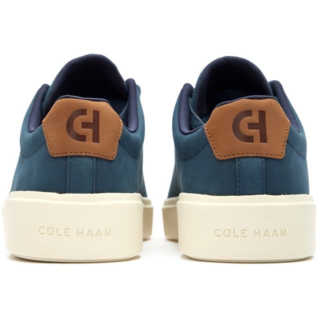 Mens blue Cole Haan grand crosscourt traveler trainers, manufactured with leather and a rubber sole. Featuring: cushioned footbed, durable rubber cupsole, soft leather upper, cole haan branding and comfort fit.