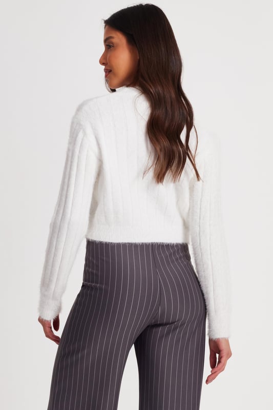 - Knitted finish - Cropped style - Long sleeves - Model height: 5' 8 " - Model wears uk 8 / us 4 / eur 36 - Always check the care wash label - Cool hand wash with mild detergent