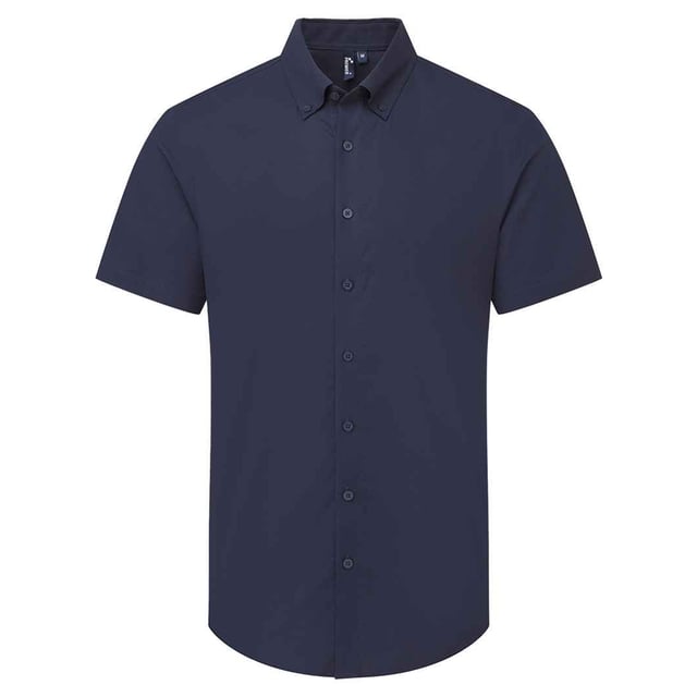 72% Mercerised Cotton, 25% Organic Cotton, 3% Elastane. Fabric: Oxford Cloth, Soft Touch. Design: Plain. Fastening: Button. Neckline: Button-Down. Hem: Curved. Sleeve-Type: Short-Sleeved. Fabric Technology: Stretch. Back Yoke, Pleated Back. 135gsm. Sustainability: Amfori, BSCI, Organic Cotton, Sedex, WRAP Certified.