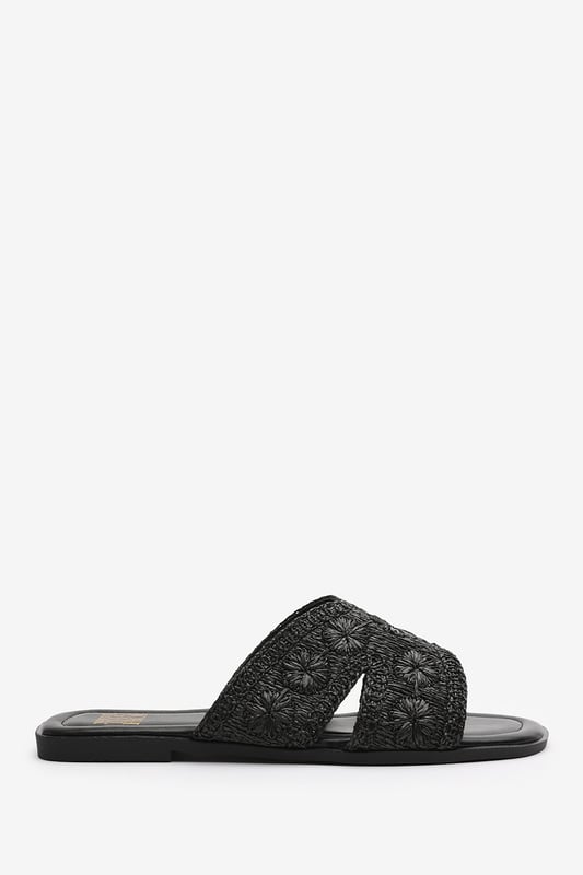 Wheres That From Womens 'Caity' Jute Floral Embroidery Flat Sandals Introducing our 'Caity' women's jute floral embroidery flat sandals, the perfect combination of style and comfort. These sliders are an essential addition to your footwear collection, offering versatility and elegance for any occasion. Key Features: Floral Detail: The stunning jute floral embroidery on the front adds a touch of glamour and makes these sliders stand out from the crowd. • Chic Design: The raffia material gives these sliders a sophisticated look that will elevate any outfit, whether you're dressing up for a special occasion or keeping it casual for daily use. • Comfortable Fit: We understand the importance of comfort, which is why these sliders are designed with a comfortable fit in mind. Slip them on effortlessly and enjoy a relaxed feel that lasts all day. • Durable Construction: Crafted with high-quality materials, these sliders are built to last. The breathable and odor-resistant foam ensures a comfortable and fresh wearing experience. • Perfect for Any Occasion: Whether you're headed to the beach, a casual outing, or a night out with friends, these versatile sliders are suitable for any occasion, adding a touch of elegance to your look. Specifications: • Material: Raffia • Closure: Slip-on • Sole: Rubber sole for comfort and traction. Invest in our 'Caity' women's jute floral embroidery flat sandals and experience the perfect blend of style, comfort, and durability. Step out with confidence and make a fashion statement with every stride.