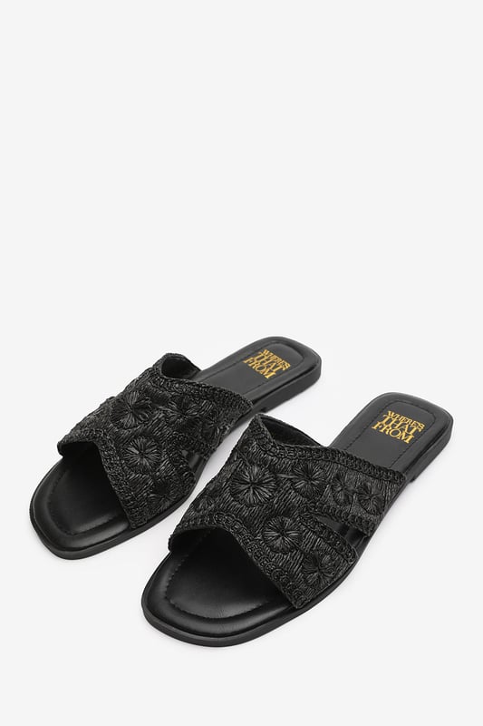 Wheres That From Womens 'Caity' Jute Floral Embroidery Flat Sandals Introducing our 'Caity' women's jute floral embroidery flat sandals, the perfect combination of style and comfort. These sliders are an essential addition to your footwear collection, offering versatility and elegance for any occasion. Key Features: Floral Detail: The stunning jute floral embroidery on the front adds a touch of glamour and makes these sliders stand out from the crowd. • Chic Design: The raffia material gives these sliders a sophisticated look that will elevate any outfit, whether you're dressing up for a special occasion or keeping it casual for daily use. • Comfortable Fit: We understand the importance of comfort, which is why these sliders are designed with a comfortable fit in mind. Slip them on effortlessly and enjoy a relaxed feel that lasts all day. • Durable Construction: Crafted with high-quality materials, these sliders are built to last. The breathable and odor-resistant foam ensures a comfortable and fresh wearing experience. • Perfect for Any Occasion: Whether you're headed to the beach, a casual outing, or a night out with friends, these versatile sliders are suitable for any occasion, adding a touch of elegance to your look. Specifications: • Material: Raffia • Closure: Slip-on • Sole: Rubber sole for comfort and traction. Invest in our 'Caity' women's jute floral embroidery flat sandals and experience the perfect blend of style, comfort, and durability. Step out with confidence and make a fashion statement with every stride.