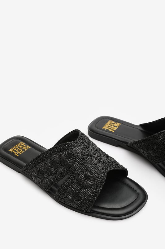 Wheres That From Womens 'Caity' Jute Floral Embroidery Flat Sandals Introducing our 'Caity' women's jute floral embroidery flat sandals, the perfect combination of style and comfort. These sliders are an essential addition to your footwear collection, offering versatility and elegance for any occasion. Key Features: Floral Detail: The stunning jute floral embroidery on the front adds a touch of glamour and makes these sliders stand out from the crowd. • Chic Design: The raffia material gives these sliders a sophisticated look that will elevate any outfit, whether you're dressing up for a special occasion or keeping it casual for daily use. • Comfortable Fit: We understand the importance of comfort, which is why these sliders are designed with a comfortable fit in mind. Slip them on effortlessly and enjoy a relaxed feel that lasts all day. • Durable Construction: Crafted with high-quality materials, these sliders are built to last. The breathable and odor-resistant foam ensures a comfortable and fresh wearing experience. • Perfect for Any Occasion: Whether you're headed to the beach, a casual outing, or a night out with friends, these versatile sliders are suitable for any occasion, adding a touch of elegance to your look. Specifications: • Material: Raffia • Closure: Slip-on • Sole: Rubber sole for comfort and traction. Invest in our 'Caity' women's jute floral embroidery flat sandals and experience the perfect blend of style, comfort, and durability. Step out with confidence and make a fashion statement with every stride.