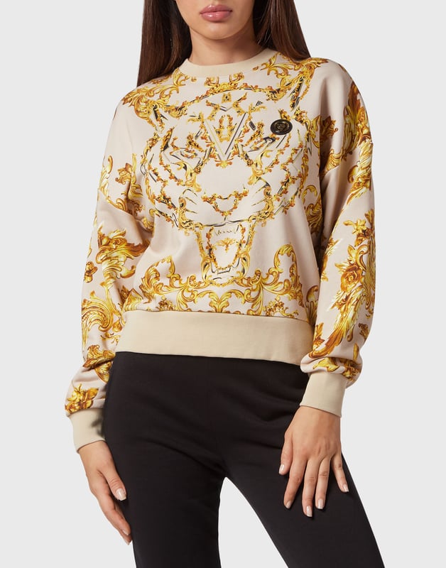 Este polar de cuello redondo es ideal para la sesión de calentamiento de cualquier actividad. Ligero, cómodo y suave.   Forro polar de algodón con forro de gasa.    Tejido con estampado barroco   Estampado de la marca en la espalda   Parche engomado de tigre cosido en el pecho izquierdo   Dobladillos de punto elástico   Ajuste: Cropped