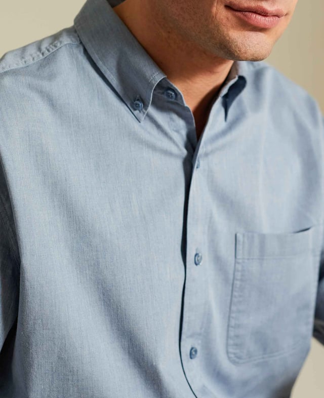 Introducing our melange button-down shirt in denim blue. A fine choice for smart-casual occasions, it looks just as good with a pair of jeans as it does with chinos or shorts. It's been given our easy-iron finish for ultimate convenience. 100% BCI cotton denim twill; fluid and supple; easy-iron finish. Generously proportioned classic fit. Button down collar. Twin needled to strengthen seams. Split yoke, long tails, chest pocket. Single cuff. Machine washable at 40°C. Shirt is presented in fully recyclable packaging.