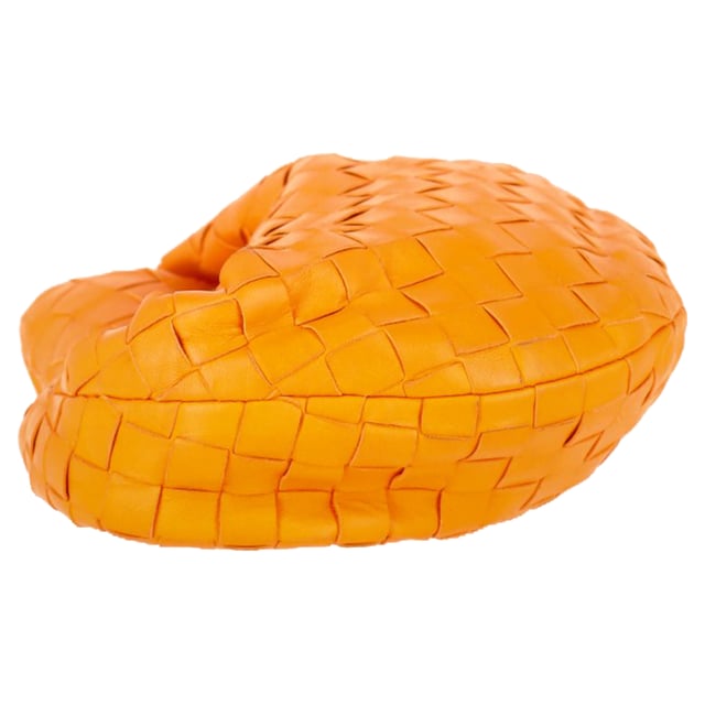 VINTAGE, RRP AS NEW
The Bottega Veneta Mini Jodie in vibrant orange intrecciato leather is the ultimate expression of compact luxury. Its sculptural silhouette and signature woven design make it instantly recognizable, while gold-tone hardware and calfskin lining add refined detail. This top-handle bag is made for effortless impact, from brunch dates to evenings out.

with dust bag

Bottega Veneta Mini Jodie in Orange Leather
Condition: Very good
Signs of wear: No retail tag, Minor sign of wear or markings., Lightly used but very well maintained. Minor creasing, light worn corners, light scratches.
Packaging: Dust bag
Color: Orange
Material: Leather | leather
Size: One Size | One Size
Measurements: Width: 260; Height: 200; Length: 250; Handle drop: 240; Strap length: 0
SKU: NAPPUGBBA475928W