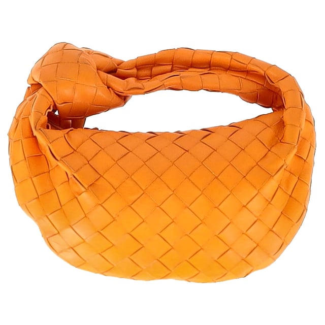 VINTAGE, RRP AS NEW
The Bottega Veneta Mini Jodie in vibrant orange intrecciato leather is the ultimate expression of compact luxury. Its sculptural silhouette and signature woven design make it instantly recognizable, while gold-tone hardware and calfskin lining add refined detail. This top-handle bag is made for effortless impact, from brunch dates to evenings out.

with dust bag

Bottega Veneta Mini Jodie in Orange Leather
Condition: Very good
Signs of wear: No retail tag, Minor sign of wear or markings., Lightly used but very well maintained. Minor creasing, light worn corners, light scratches.
Packaging: Dust bag
Color: Orange
Material: Leather | leather
Size: One Size | One Size
Measurements: Width: 260; Height: 200; Length: 250; Handle drop: 240; Strap length: 0
SKU: NAPPUGBBA475928W