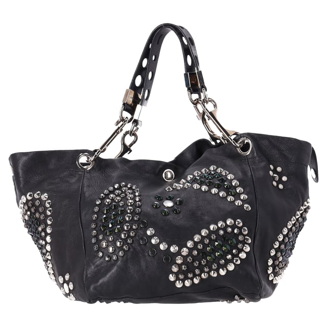 VINTAGE, RRP AS NEW
The Jimmy Choo Lola Hobo Bag is where luxury meets edge. Crafted from ultra-soft lambskin leather, this slouchy bag is adorned with bold studs and intricate mosaic pattern cutouts, adding a glamorous twist to an iconic shape. With its relaxed silhouette and attention-grabbing details, it’s a perfect companion for the fashion-forward woman who wants to turn heads wherever she goes.



Jimmy Choo Studded Lola Hobo Bag in Black Lambskin Leather 
Condition: Very good
Signs of wear: No retail tag, Minor sign of wear or markings., 
Packaging: None
Color: black
Material: Leather | leather
Size: One Size | One Size
Measurements: Width: 280; Height: 470; Length: 300; Handle drop: 0; Strap length: 560
SKU: NAPPUDEBA471166W