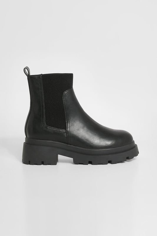 Chunky sole design for a bold, contemporary look
        Elastic side panels for easy slip-on and off
        Flat heel height between 0 and 2cm for all-day comfort
        Durable synthetic materials for long-lasting wear
        Wide fit to accommodate various foot shapes
    
    Step out in style with these wide fit chunky sole Chelsea boots, perfect for the fashion-forward trendsetter. The robust design combines practicality with edgy appeal, making them a versatile addition to your footwear collection. Pair them with cropped jeans and an oversized jumper for a casual daytime look, or dress them up with a flowy midi dress and leather jacket for an evening out. These boots are ideal for various casual occasions, from family gatherings to weekend brunches with friends. The flat heel ensures comfort for extended wear, while the wide fit caters to those seeking a roomier option. Embrace the street-style aesthetic and make a statement with every step in these eye-catching boots that effortlessly blend comfort and contemporary fashion.