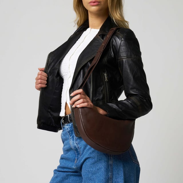 Everyday style with this beautifully crafted cross body bag in rich ruby chocolate brown. Made from supple real goat leather, this bag features a secure zip closure and an adjustable strap for a comfortable, custom fit. Compact and stylish, it’s perfect for carrying your daily essentials with ease and sophistication.