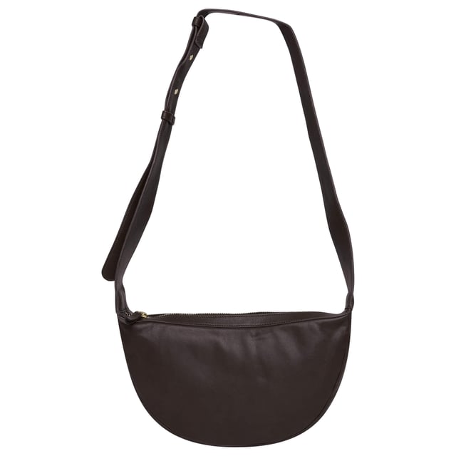 Everyday style with this beautifully crafted cross body bag in rich ruby chocolate brown. Made from supple real goat leather, this bag features a secure zip closure and an adjustable strap for a comfortable, custom fit. Compact and stylish, it’s perfect for carrying your daily essentials with ease and sophistication.