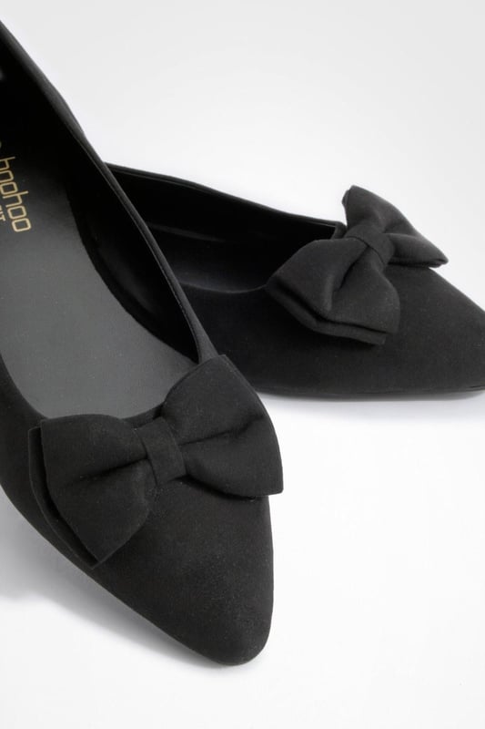 Charming bow detail adorns the toe
        Wide fit design for enhanced comfort
        Versatile round toe silhouette
        Flat sole for all-day wearability
        Soft synthetic suede upper for a luxe look
    
    Step out in style and comfort with these delightful wide fit ballerina flats. The eye-catching bow detail adds a touch of femininity to the classic round toe design, making these shoes a perfect blend of elegance and practicality. Ideal for the fashion-forward woman who values both style and comfort, these flats can effortlessly transition from day to night. Pair them with cropped trousers and a crisp white shirt for a polished office look, or team them with a flowy summer dress for a casual day out with friends. The versatile nature of these ballerinas makes them a wardrobe essential for various occasions, from family gatherings to impromptu coffee dates. With their wide fit and soft synthetic suede upper, these shoes promise to keep your feet feeling fabulous all day long, no matter where your adventures take you.