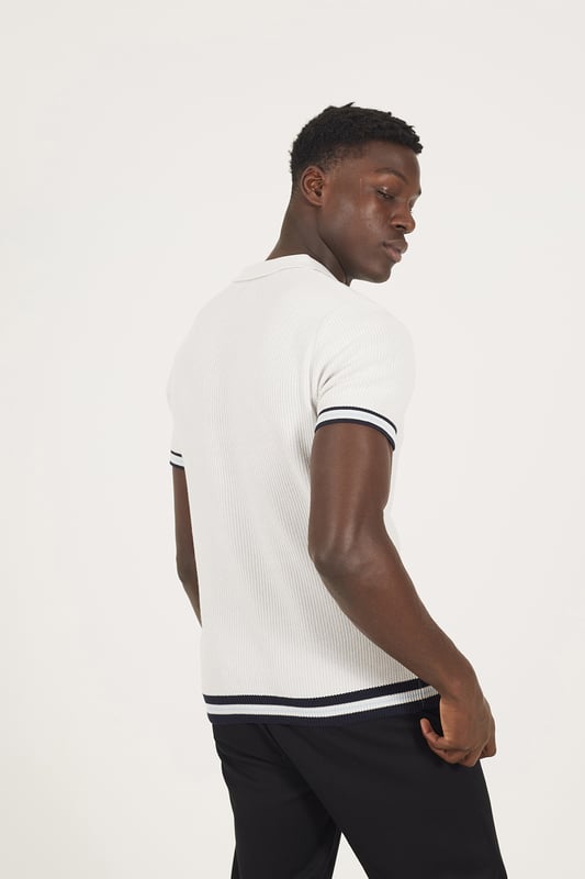 Elevate your smart-casual style with this polo from Brave Soul, designed with a sleek concealed 1/4 zip neck fastening for a clean, contemporary finish. Made from an all-over rib knit fabric, this polo offers a comfortable stretch fit with refined texture. Contrast stripe trims at the collar and cuffs add a pop of detail, to this elevated everyday essential. Model wears UK size M.