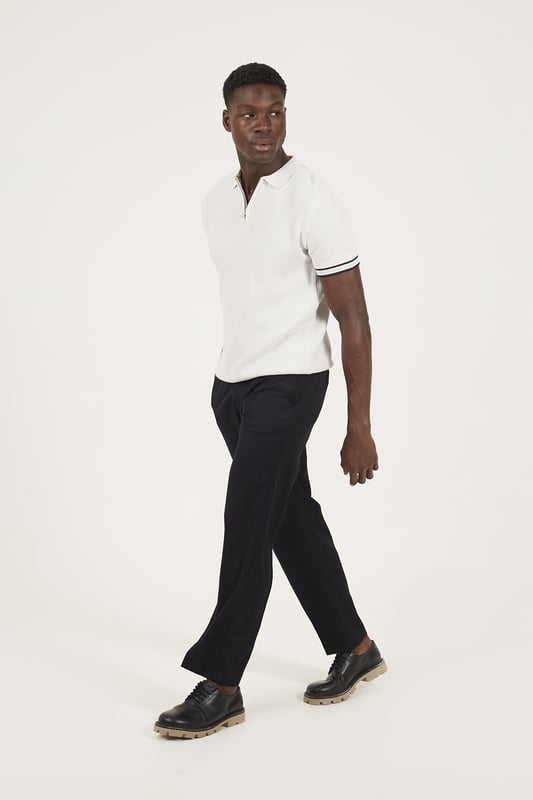 Elevate your smart-casual style with this polo from Brave Soul, designed with a sleek concealed 1/4 zip neck fastening for a clean, contemporary finish. Made from an all-over rib knit fabric, this polo offers a comfortable stretch fit with refined texture. Contrast stripe trims at the collar and cuffs add a pop of detail, to this elevated everyday essential. Model wears UK size M.